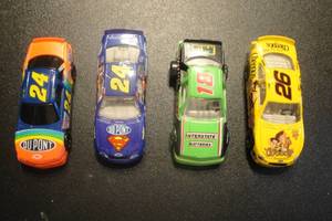 lot 25 image: 4- Collectible Die Cast Race Cars, 1- 1990 # 24 Racing Champions, 1- 1999 # 24 Hasbro, 1-1990 #18 Matchbox Pit Row, 1- 1999 #26 Hot Wheels, 4 X Money