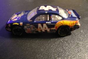 lot 55 image: 4- Collectible 164 Scale Die Cast Race Cars, 1-1996 Special Edition #44 Kyle Petty, Buzz Lightyear Hot Wheels, 1-1991 # 42 Kyle Petty, Mello Yello 4 X Money