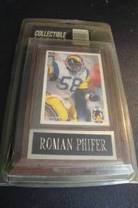 lot 93 image: Removable Rams, Roman Phifer Collector Card in Plastic Sleeve Mounted on Wall Plaque.