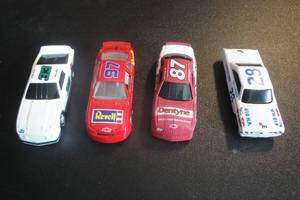 lot 114 image: 4-Die Cast Collectible Race Cars,  4X Money