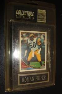 lot 195 image: Topps Removable Roman Phifer, Rams, Collector Card in Plastic Sleeve Mounted on Wall Plaque