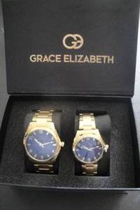 lot 7 image: His and Hers Matching Grace Elizabeth Watch Set, Gold Tone with Dark Blue Faces, New in Box