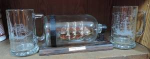 lot 28 image: ship in a bottle and 2 mugs with ships on them