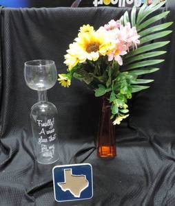 lot 59 image: bottle wine glass  vase with artificial flowers  Texas picture frame