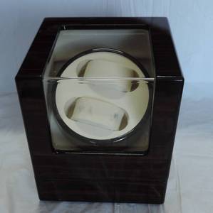 lot 79 image: Watch display case battery operated and plugs in no plug but works on batteries
