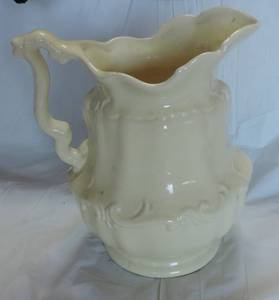 lot 80 image: Cream colored pitcher approximately 12 inch tall