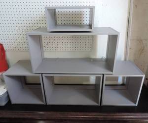 lot 136 image: Shelf system that could be changed multiple different ways picture of it together and picture of it apart