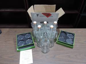 lot 370 image: 6 -16oz resealable bottles one missing the top & 7 glass weights for canning