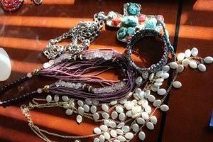 lot 74 image: Jewelry Chunky Howlite cross necklace, Faux pearl multi strand necklace, Amethyst and purple bead necklace, and hinged bracelet