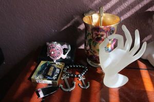 lot 73 image: Jewelry Glass pendants, Hematite bracelet, flower vase, hand statue, and more