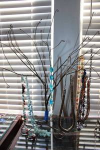 lot 87 image: Wire jewelry tree and necklaces as shown
