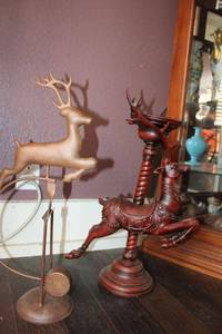 lot 104 image: Reindeer metal rocking stand and wood carved candle stand