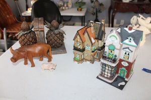 lot 50 image: Pineapple bookends, wood and stone carved oxen, village houses