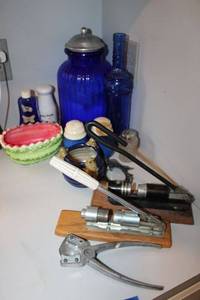 lot 178 image: Blue glass cannister, blue bottle, salt and pepper shakers, small watermelon bowl, and hand lever nut crackers