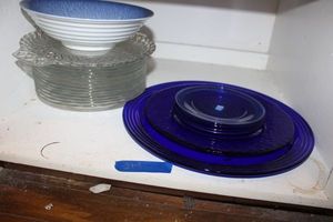 lot 214 image: Blue glass plates, clear glass plates, and blue and white bowl