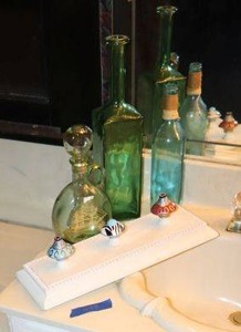 lot 448 image: Green glass bottles and doorknob decorative panel