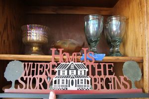 lot 432 image: Iridescent glassware and metal Home sign