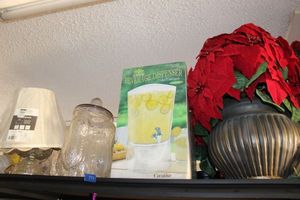 lot 597 image: Artificial Poinsettia, beverage dispenser, Planters Peanut jar, table lamps and more