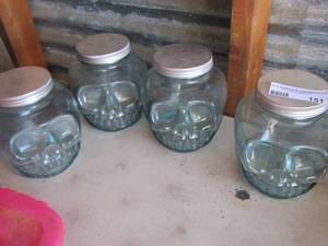 lot 151 image: qty4 glass skull canisters one has a missing piece of glass