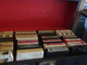 lot 235 image: handled case full of 8 track tapes