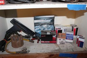 lot 185 image: Timing Light Distributor Cap and Vaiety of Other Auto Parts as shown in Photos