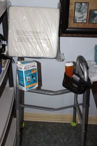 lot 415 image: Walker, Thick Seat Cushion, and insulin Test Supplies