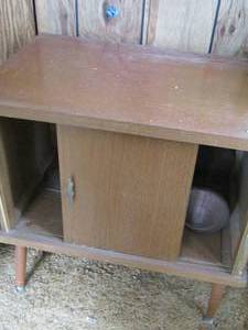 lot 11 image: small brown side table missing one door