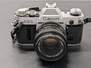 lot 74 image: Canon AE-1 35mm Film Camera w Canon FD 50mm f1.8 Lens