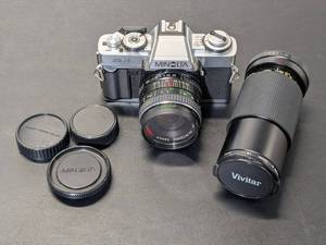 lot 166 image: Minolta XG-1 35mm Film Camera w Albinar 28mm f2.5 Lens & Vivitar 70-120mm f4.5 Lens