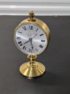 lot 233 image: Hamilton Swiss made brass wind up desk alarm clock, rare small Hamilton clock
