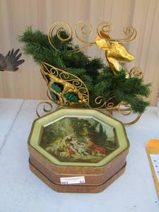 lot 63 image: Gold Buck with greenery in golden sleigh - tin can with lid