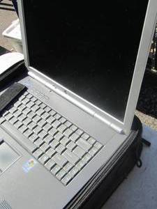 lot 253 image: computer and bag comes with charger and battery, unknown if item is in working order