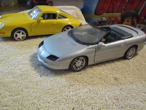 lot 130 image: 2 model cars one yellow one silvergrey