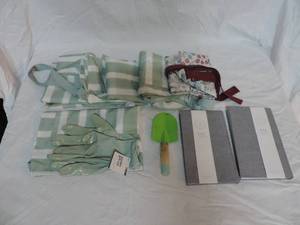 lot 35 image: Six aprons one pair of gardening gloves two journals and a small shovel