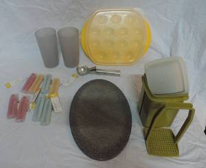 lot 39 image: Eight reusable straws  two plastic cups  egg holder tray with lid  small cutting board  ice cream scoop small green Tupperware with lid and strainer as seen in picture