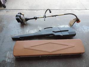 lot 75 image: Ryobi 4-cycle weed eater and two rifle cases