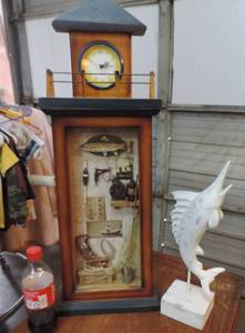 lot 133 image: Fishing picture with clock on top unknown if it works swordfish and I believe its made of wood