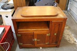lot 187 image: Entertainment table the top swivels pull out shelf on the right two doors has shelf behind them