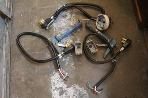 lot 205 image: Three plugs and some electrical stuff and two caulking guns