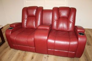 lot 7 image: Red Dual reclining loveseat. Cup holders have light, seat controls, and USB port