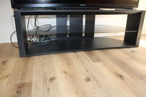 lot 14 image: Black TV stand with glass shelf, see photos