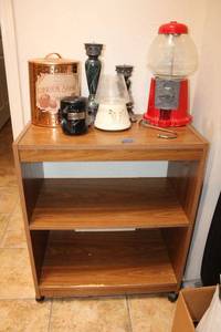 lot 57 image: Rolling cart with candy dispenser, candle holders and cookie copper tin