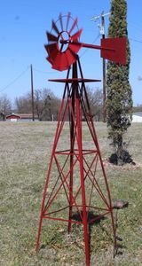 lot 2 image: Large Red Metal Windmill (must bring tools and help to remove this. Approx 8ft tall and this is in the ground and will need to be pulleddug up.