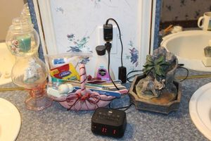 lot 54 image: Elephant Water Fountain, Alarm Clock, Manicure Items and Glass Dcor with Angel and Candle inside