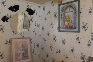 lot 63 image: Round Mirror, Two Prints and Black Ceramic Wall Dcor