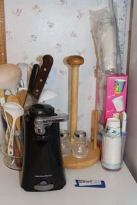 lot 236 image: Can Opener, Paper Towel Holder, Salt and Pepper Shakers, Paper Cups with Holder, Cooking Utensils and Knives with Holder