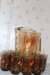 lot 240 image: Vintage Iridensent Juice Pitcher and Vintage Butterfly Juice Glasses