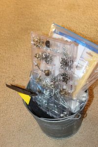 lot 364 image: Useful Bucket of things, Night Light and bulbs, Plugs, Hardware and Hooks, Plate Hangers and stands
