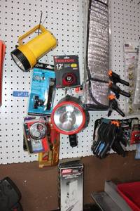 lot 12 image: Misc. lot door locks, pad locks, flashlights, Car windshield shades, clamps, and battery replacement terminals