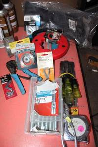 lot 17 image: Electrician and Misc. tools wedge anchors, chisel set, wire thimble, steel wire, mounting brackets, steel fish tape reels, and gloves